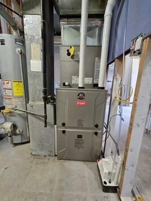 Bryant furnace unit installed in basement with ductwork and electrical connections